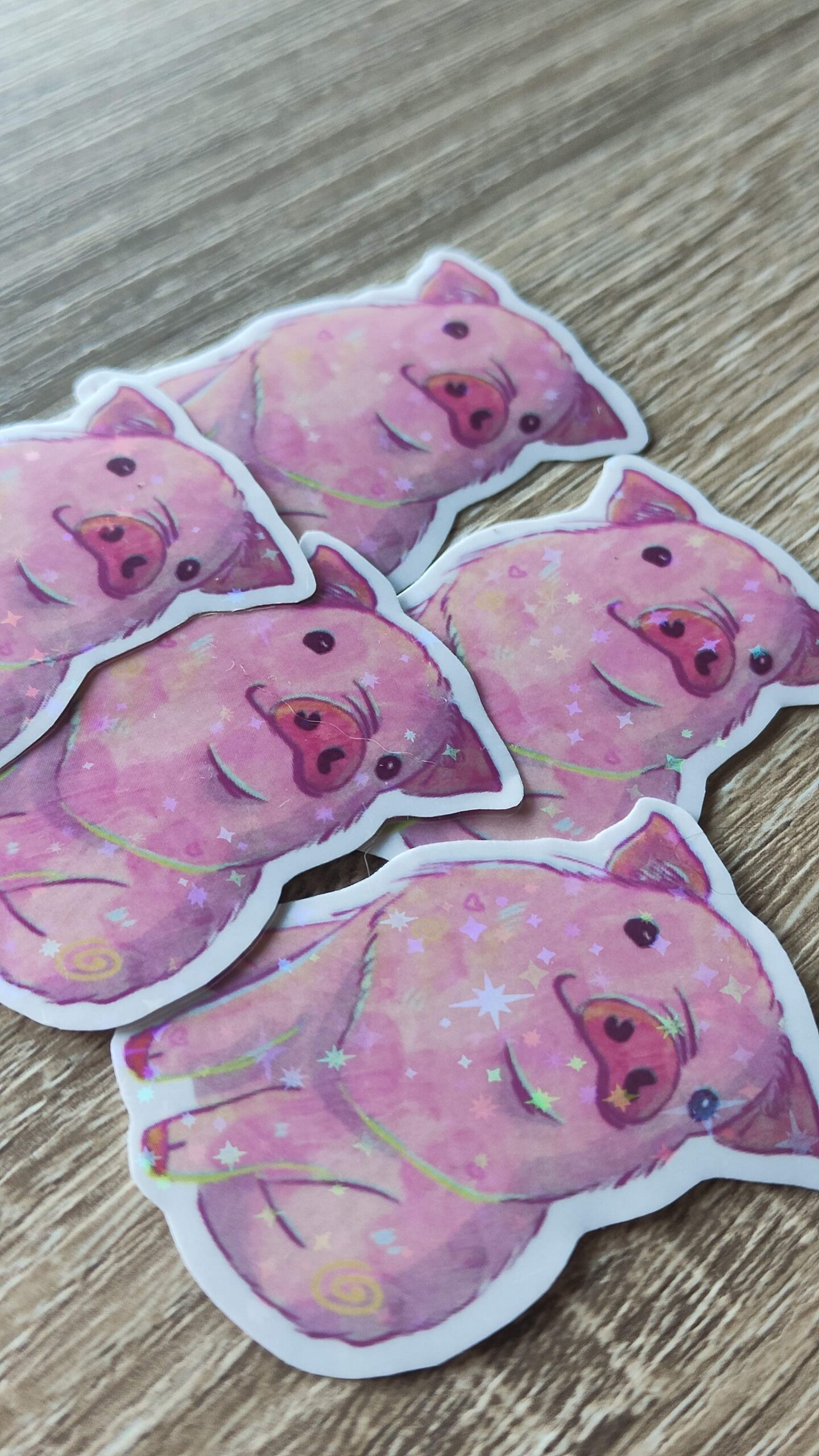 Five holographic stickers of pink pigs.
